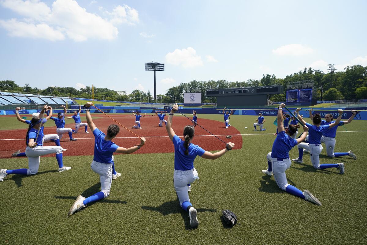 Players on Italy's softball team warm up during a training session at Fukushima Azuma Baseball Stadium.