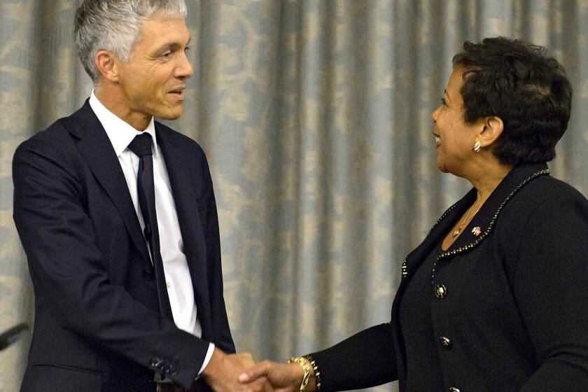 U.S. Attorney General Loretta Lynch greets her Swiss counterpart, Michael Lauber, during a news conference in Zurich, Switzerland, on Monday.