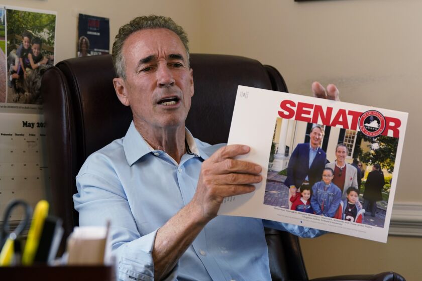Virginia state Sen. Joe Morrissey displays his annual calendar during an interview in his office, Monday, May 22, 2023, in Richmond, Va. Morrissey is being challenged in a Democratic primary for a newly redrawn senatorial district by former Delegate Lashrecse Aird. (AP Photo/Steve Helber)