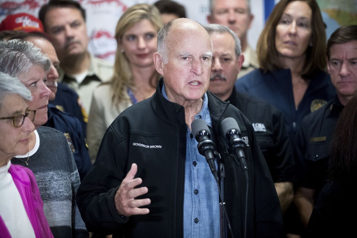 California Gov. Jerry Brown discusses the Thomas fire and the extended length of the state's fire season during a news conference on Saturday in Ventura.