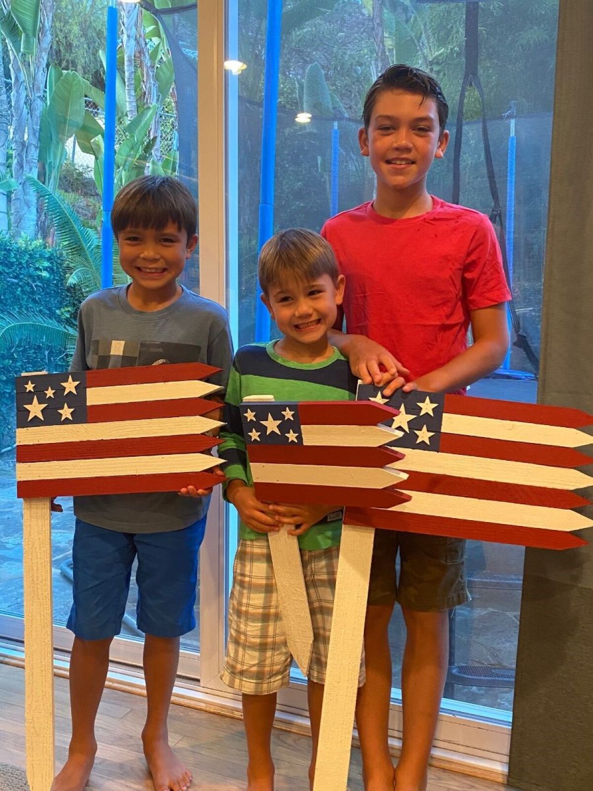 Nadine Utz says her sons Mason, 9, A.J., 6, and Wesley, 11, started assembling and painting wooden flags in June.