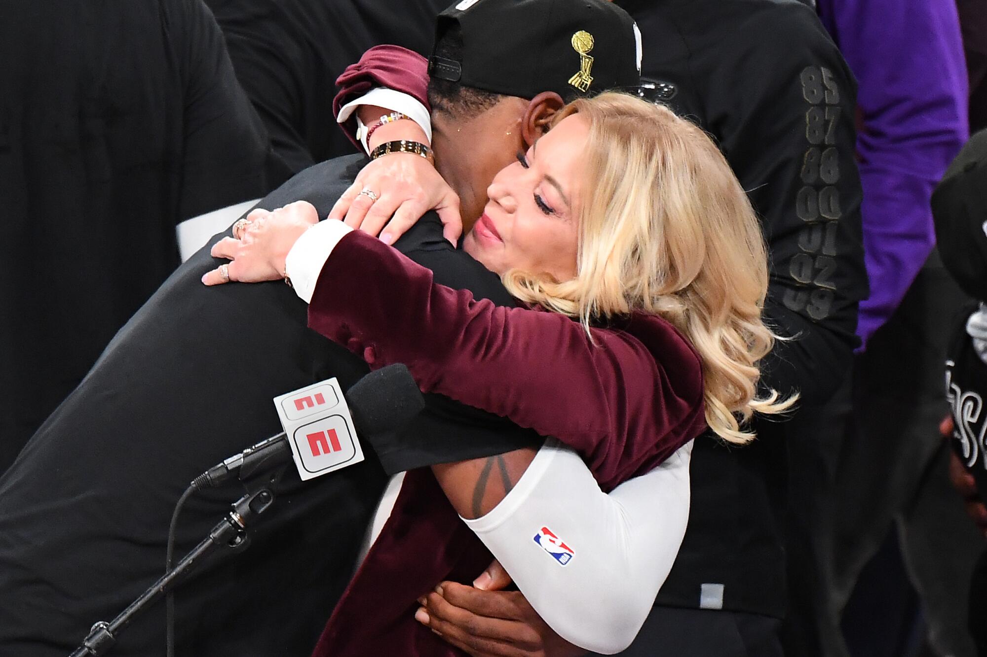 Lakers co-owner Jeanie Buss gets a hug from LeBron James after the team won the NBA championship.