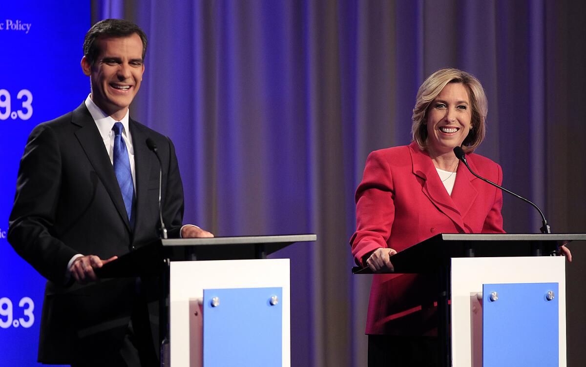 Los Angeles mayoral candidates Eric Garcetti and Wendy Greuel chat before they square off in a debate at USC's Health Sciences Campus in April.