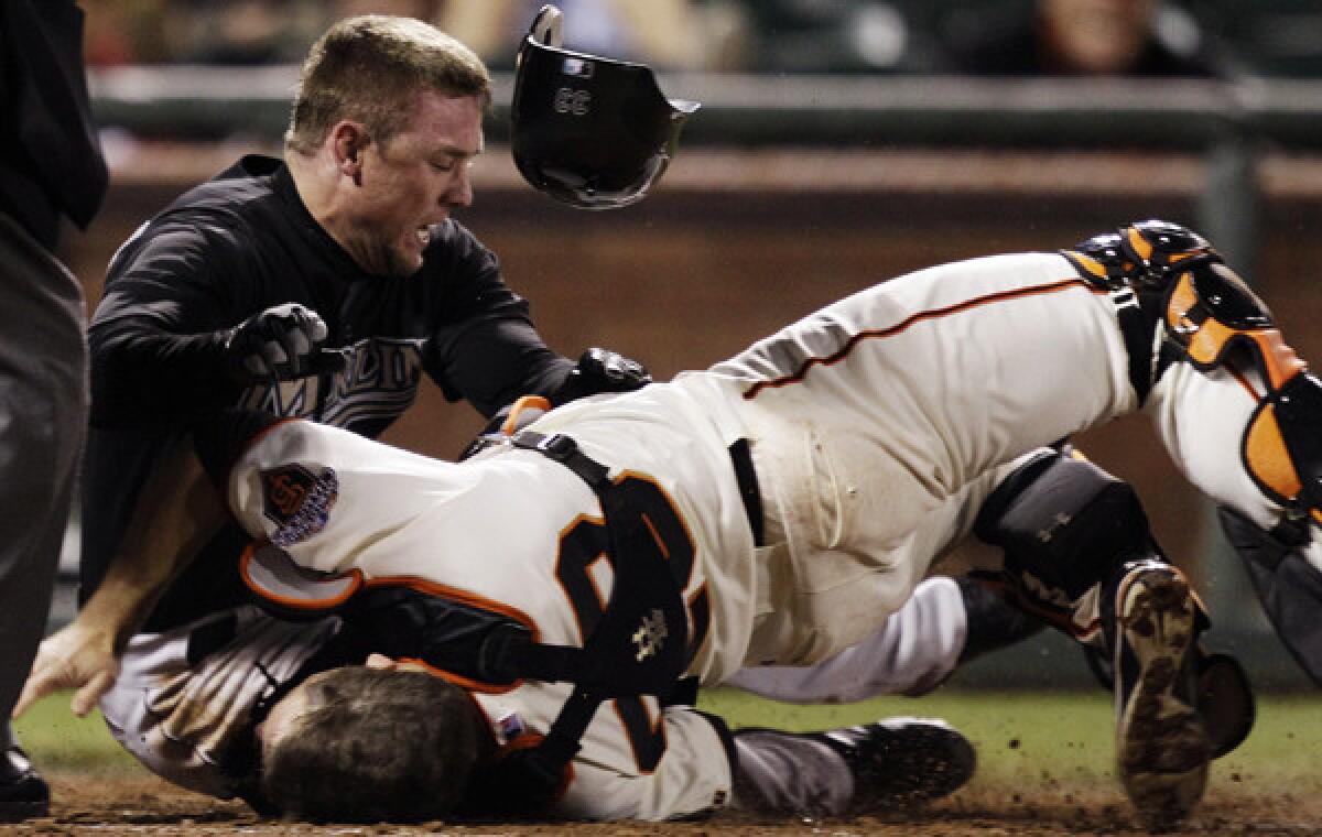 Florida Marlins baserunner Scott Cousins, left, collides with San Francisco Giants catcher Buster Posey during a game in May 2011. A new rule that will be implemented in 2014 looks to significantly cut down on dangerous plays at home plate.