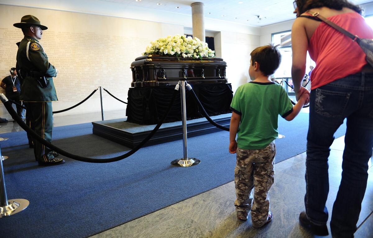 People come to pay their respects in front of the casket of former First Lady Nancy Reagan as she lies in repose at the Reagan Presidential Library in Simi Valley Wednesday.