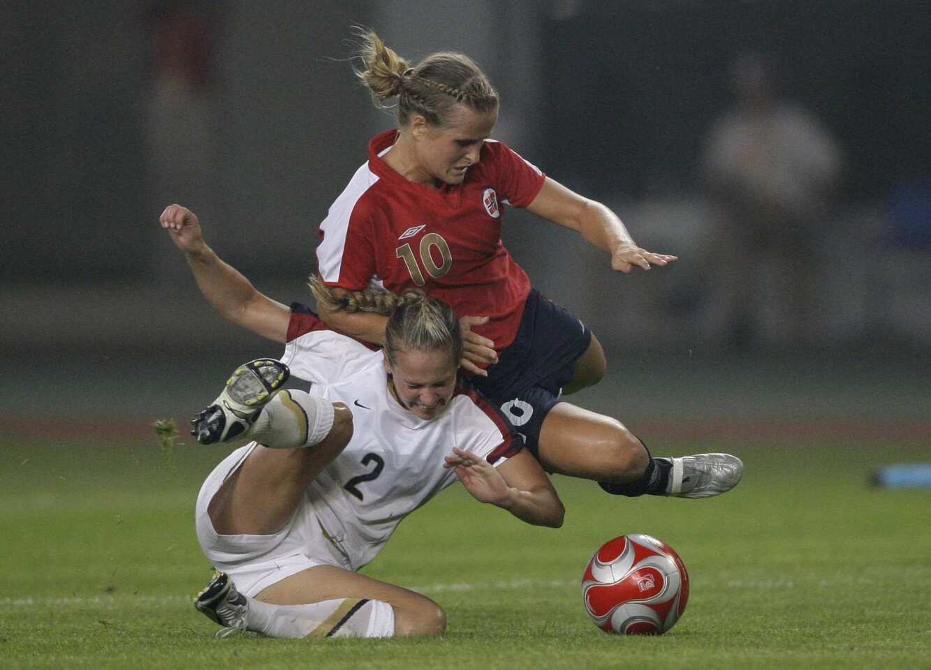 The United States' Heather Mitts, bottom, fights for the ball with Norway's Melissa Wiik during their match at the 2008 Beijing Olympics.