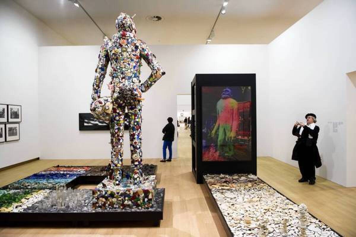 Visitors look at an art installation by American artist Mike Kelley during an exhibition at the Stedelijk Museum in Amsterdam, the Netherlands.