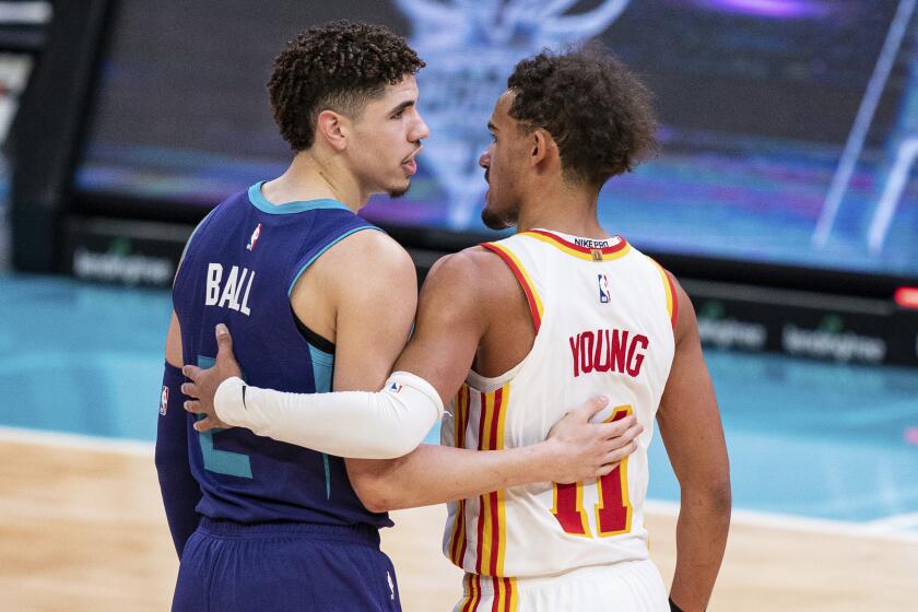 Charlotte Hornets guard LaMelo Ball (2) and Atlanta Hawks guard Trae Young (11) talk to each other after an NBA basketball game in Charlotte, N.C., Saturday, Jan. 9, 2021. The Hornets won 113-105. (AP Photo/Jacob Kupferman)