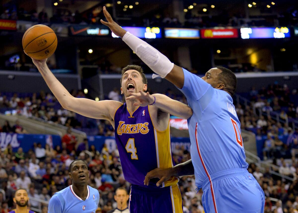 Lakers forward Ryan Kelly drives against Clippers forward Glen Davis on April 6.