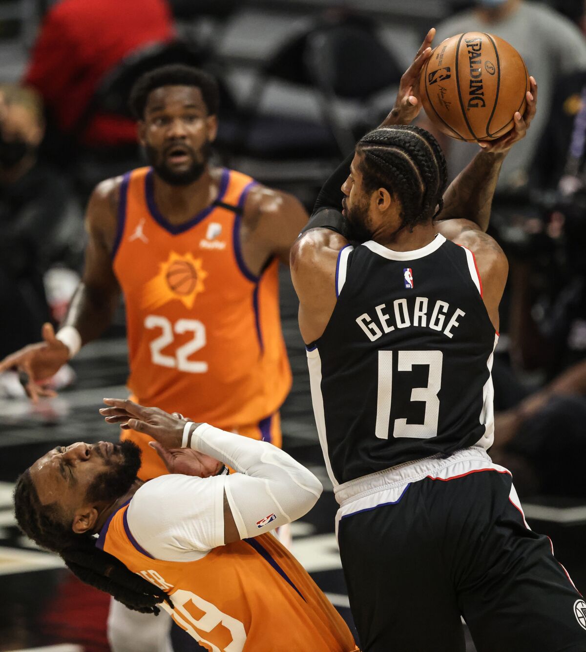 Suns forward Jae Crowder recoils after getting hit in the face by an elbow of Clippers forward Paul George.