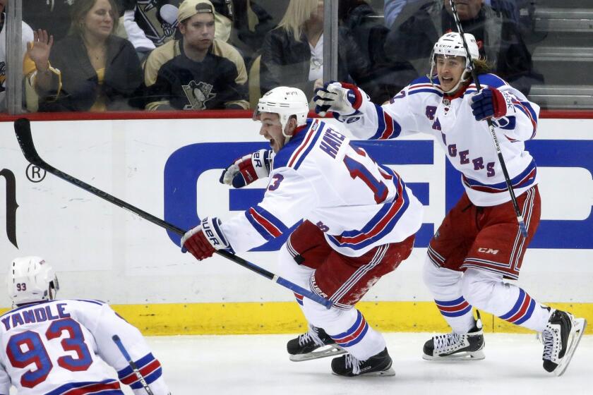 Rangers right wing Kevin Hayes (13) celebrates his game-winning overtime goal against the Penguins with teammate Carl Hagelin Wednesday night.