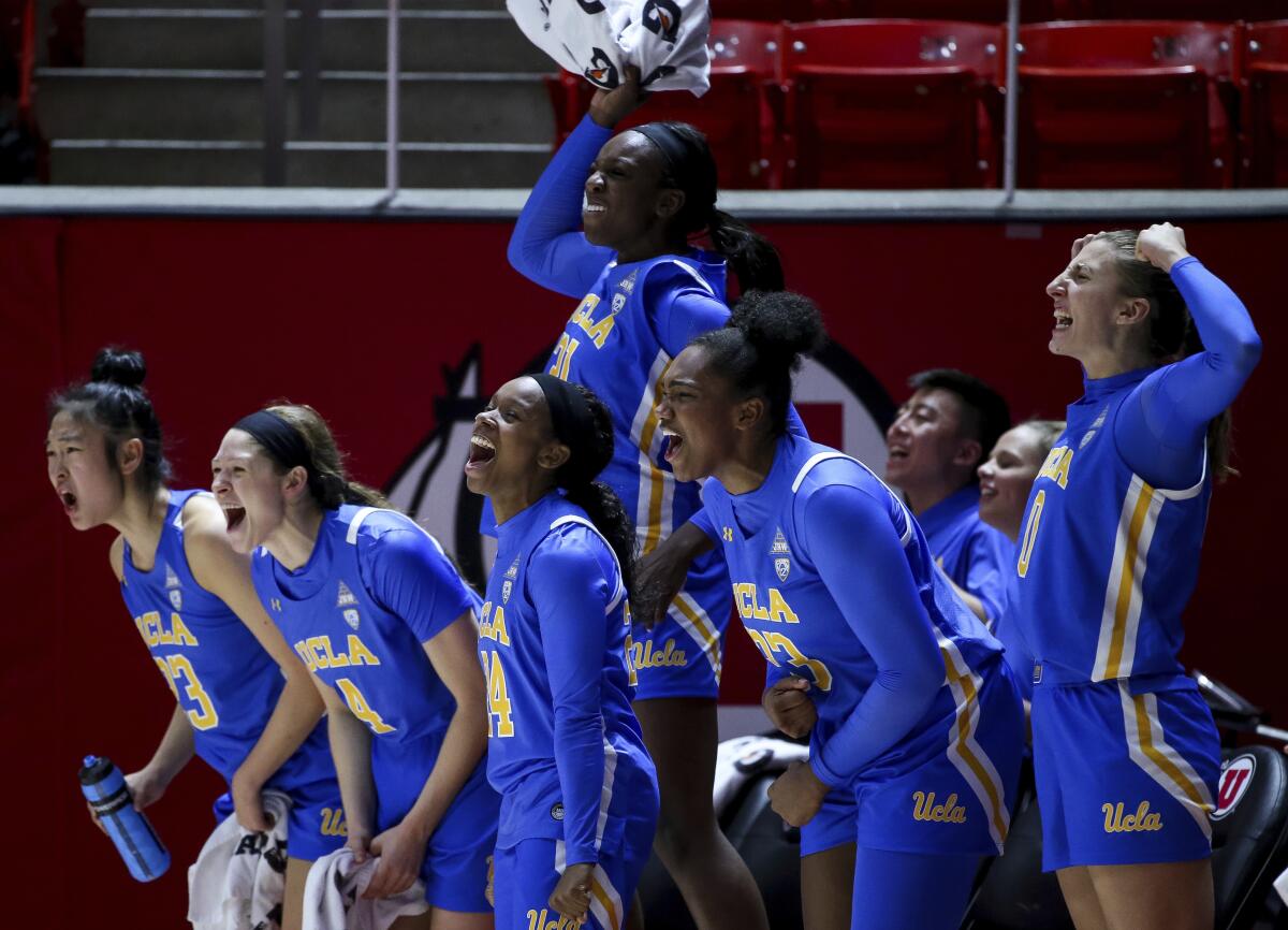 Players on UCLA's bench cheer during the final moments of the Bruins' 84-54 victory over Utah on Jan. 10, 2020.