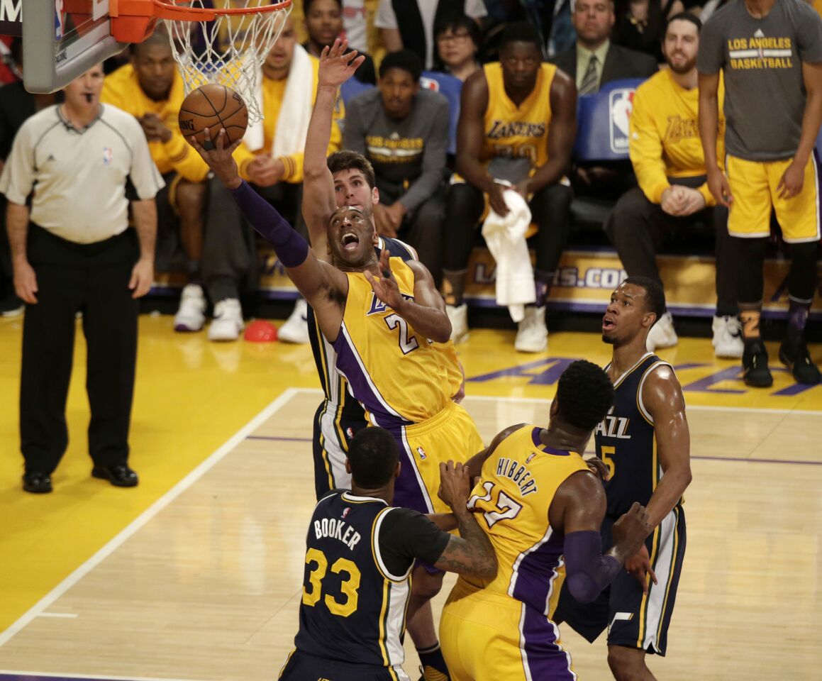 Kobe Bryant drives to the basket during the first half of his final NBA game.