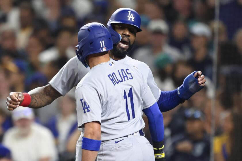 Los Angeles Dodgers' Miguel Rojas (11) celebrates with Jason Heyward after hitting a two-run home run.