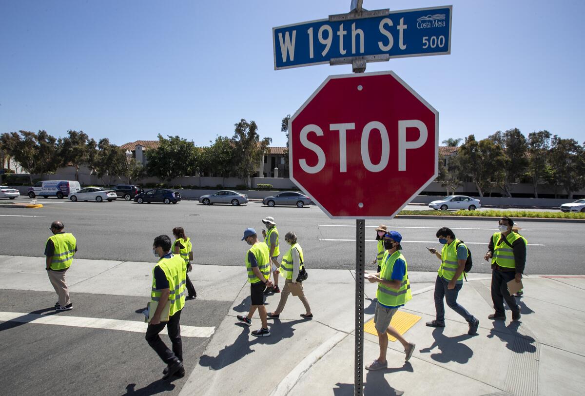 Consultants, city staff and officials walk along 19th Street in Costa Mesa during a walking audit Wednesday.