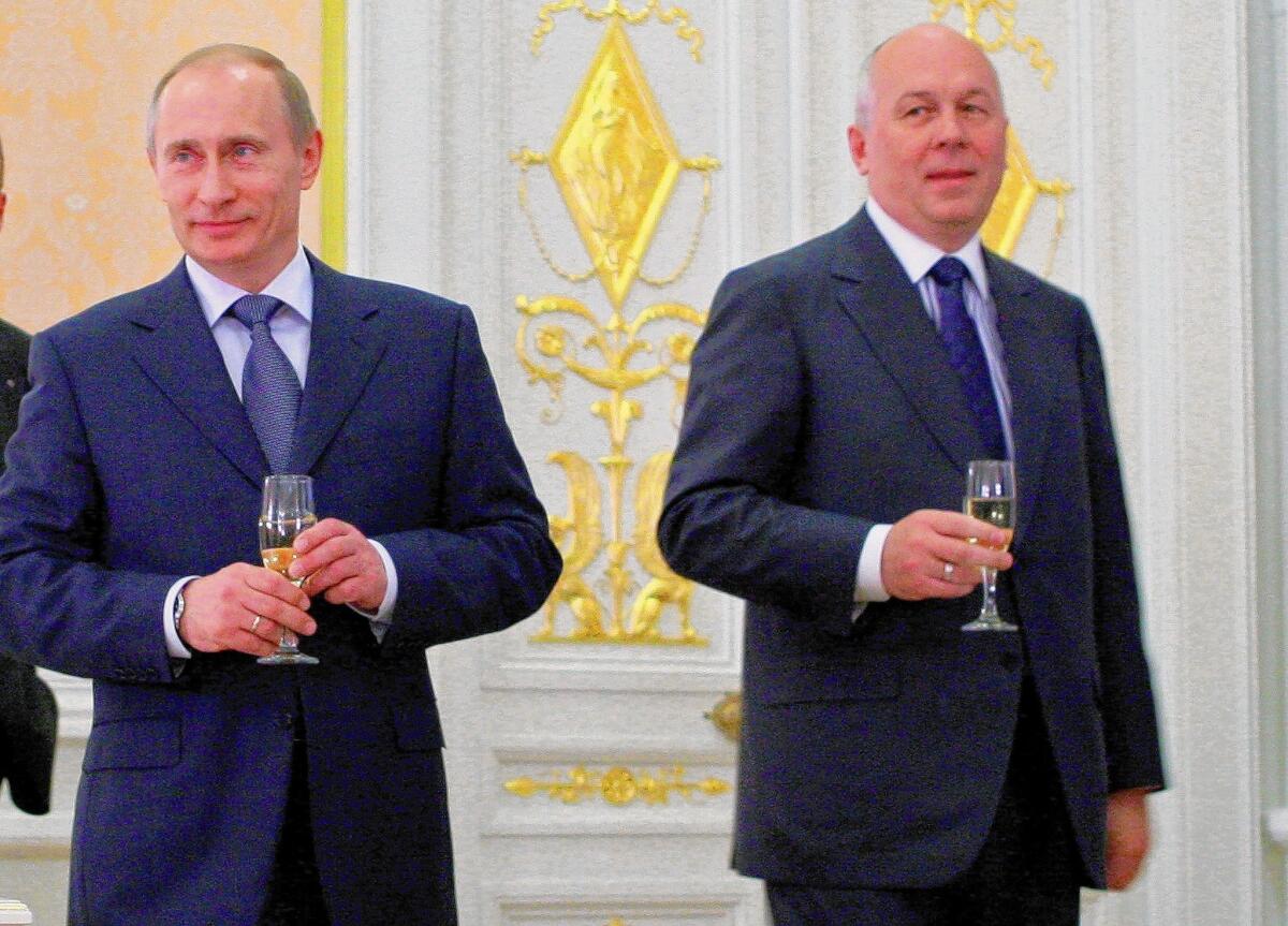 Vladimir Putin, left, and Sergei Chemezov are pictured after signing a deal in Moscow in 2009. Chemezov, head of the technology and defense firm Rostec, is one of the Russians on a new U.S. sanctions list.