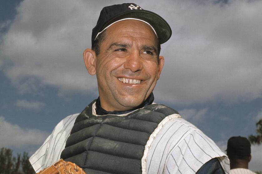 New York Yankee catcher Yogi Berra poses at spring training in Florida, in an undated file photo.