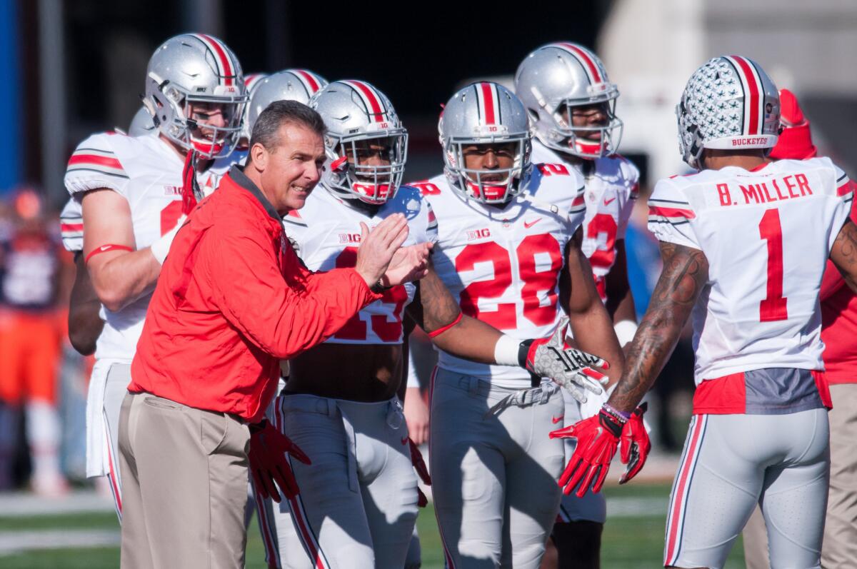 Ohio State Coach Urban Meyer encourages his Buckeye team during warm ups before a game against Illinois on Nov. 14.