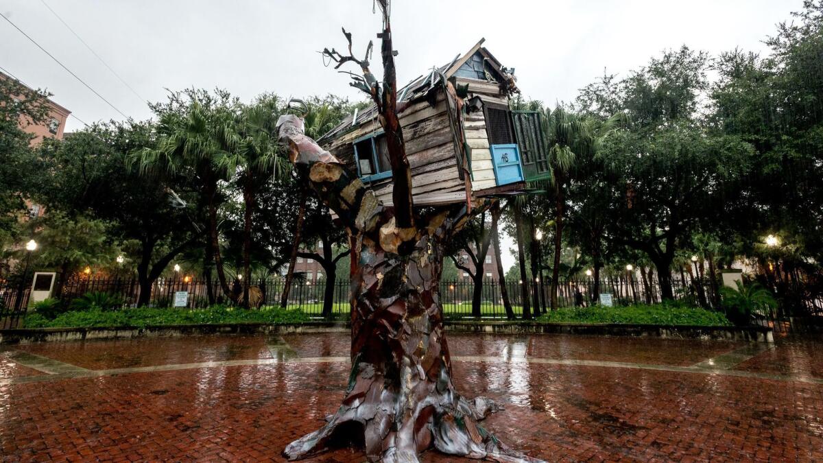 Rain falls Tuesday on the "Scrap House," artist Sally Heller's memorial to victims of Hurricane Katrina in front of the Morial Convention Center in New Orleans.