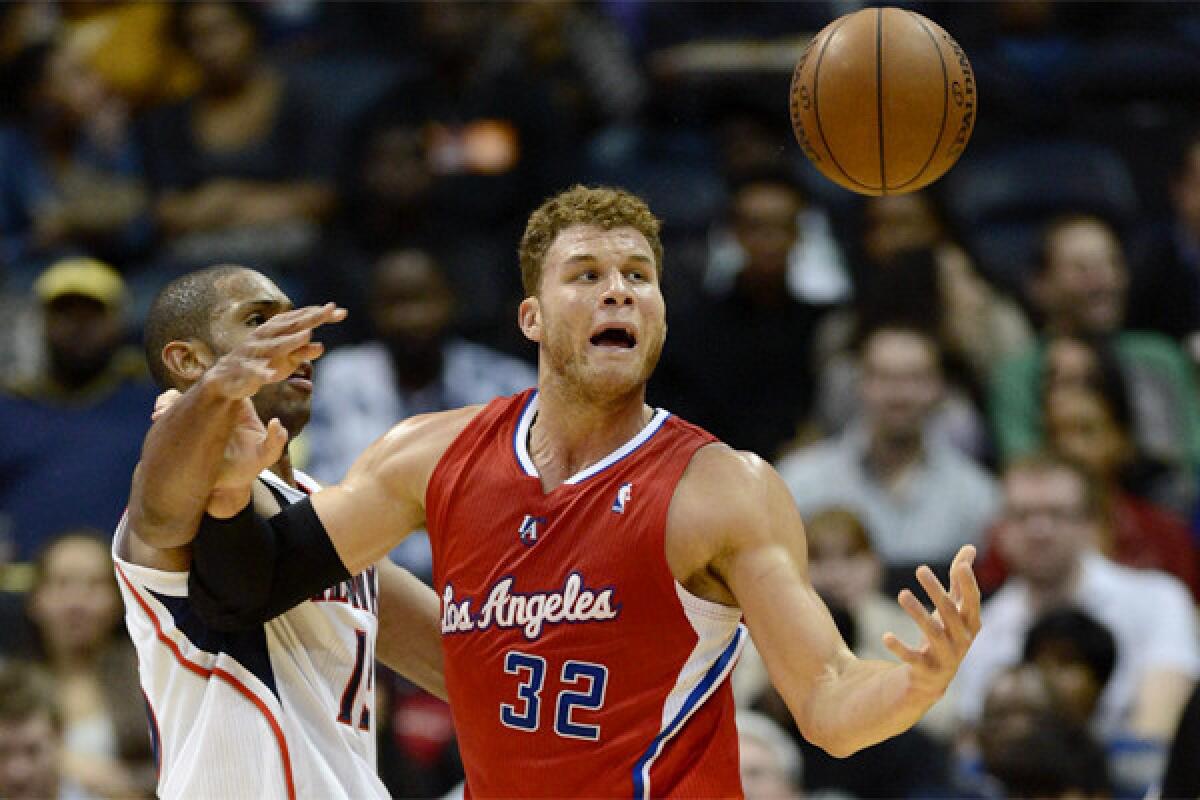 Blake Griffin loses control of the ball while being defended by Atlanta's Al Horford during the Clippers' 104-93 loss to the Hawks on Saturday.