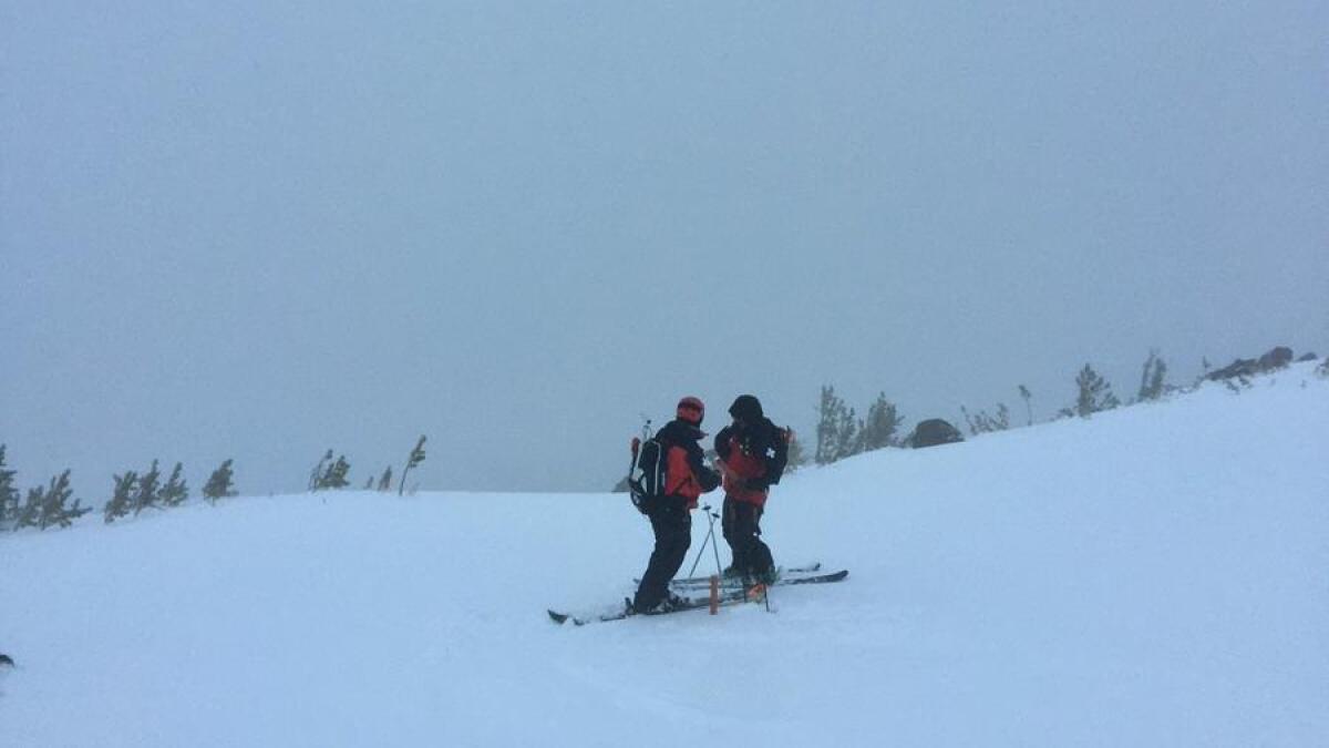 Mammoth Mountain ski patrol members clear avalanche chutes on Sunday morning after a night of snow.