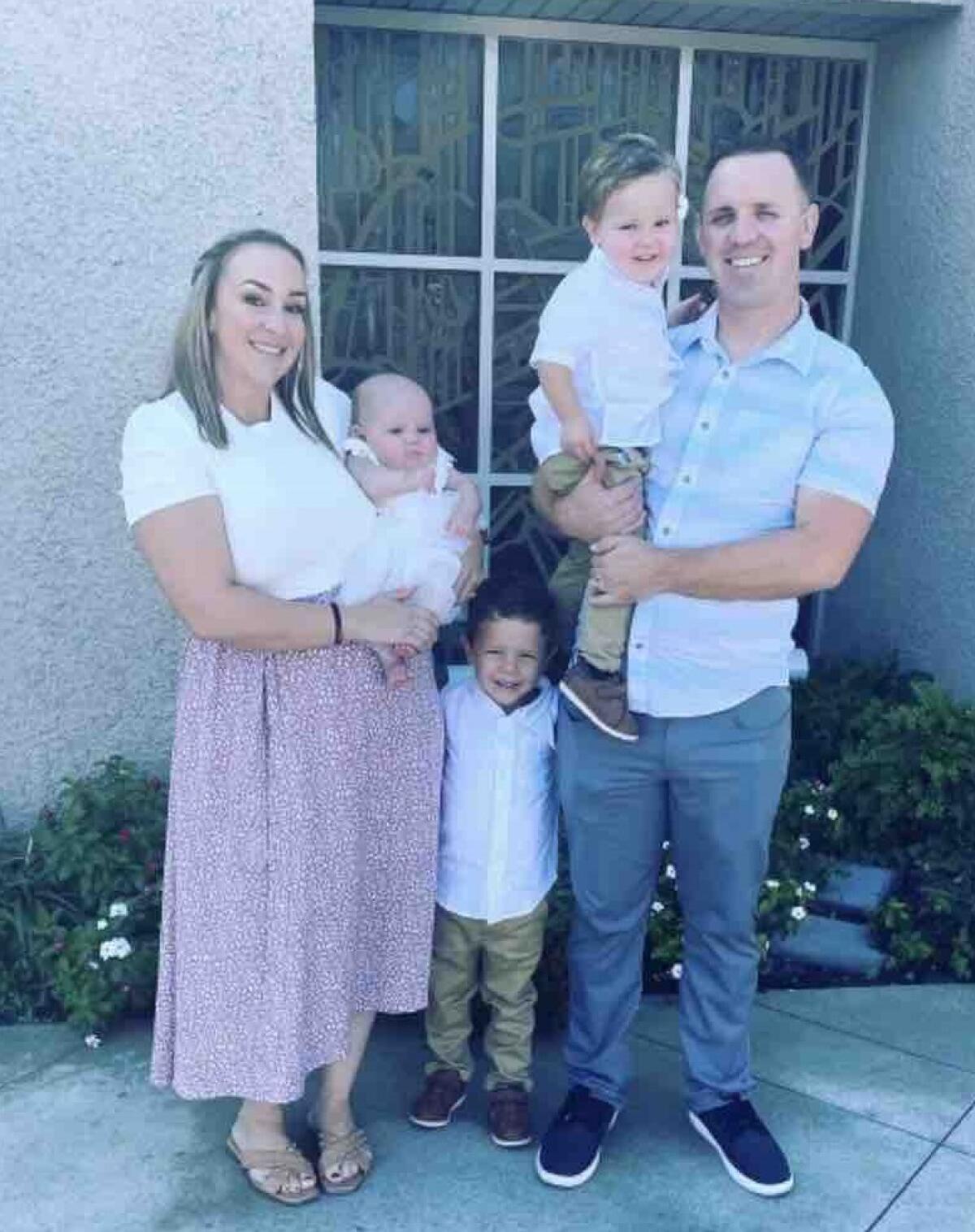 Huntington Beach Police Officer Jeremy Roberts poses for a photo with his wife, Katie Roberts, and their three children.