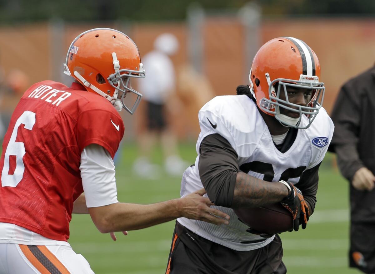 Cleveland quarterback Brian Hoyer hands the ball off to running back Trent Richardson on Wednesday, the same day Richardson was traded to Indianapolis and Hoyer was named the Browns' starting QB for this week.