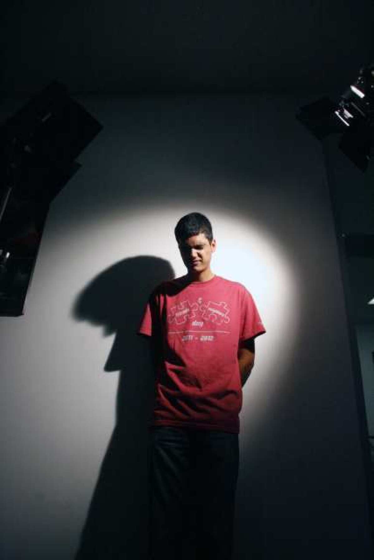Armen Ter-Zakarian, 19, stands between two lights during a lighting and camera class at International Academy of Film and Television in Burbank.
