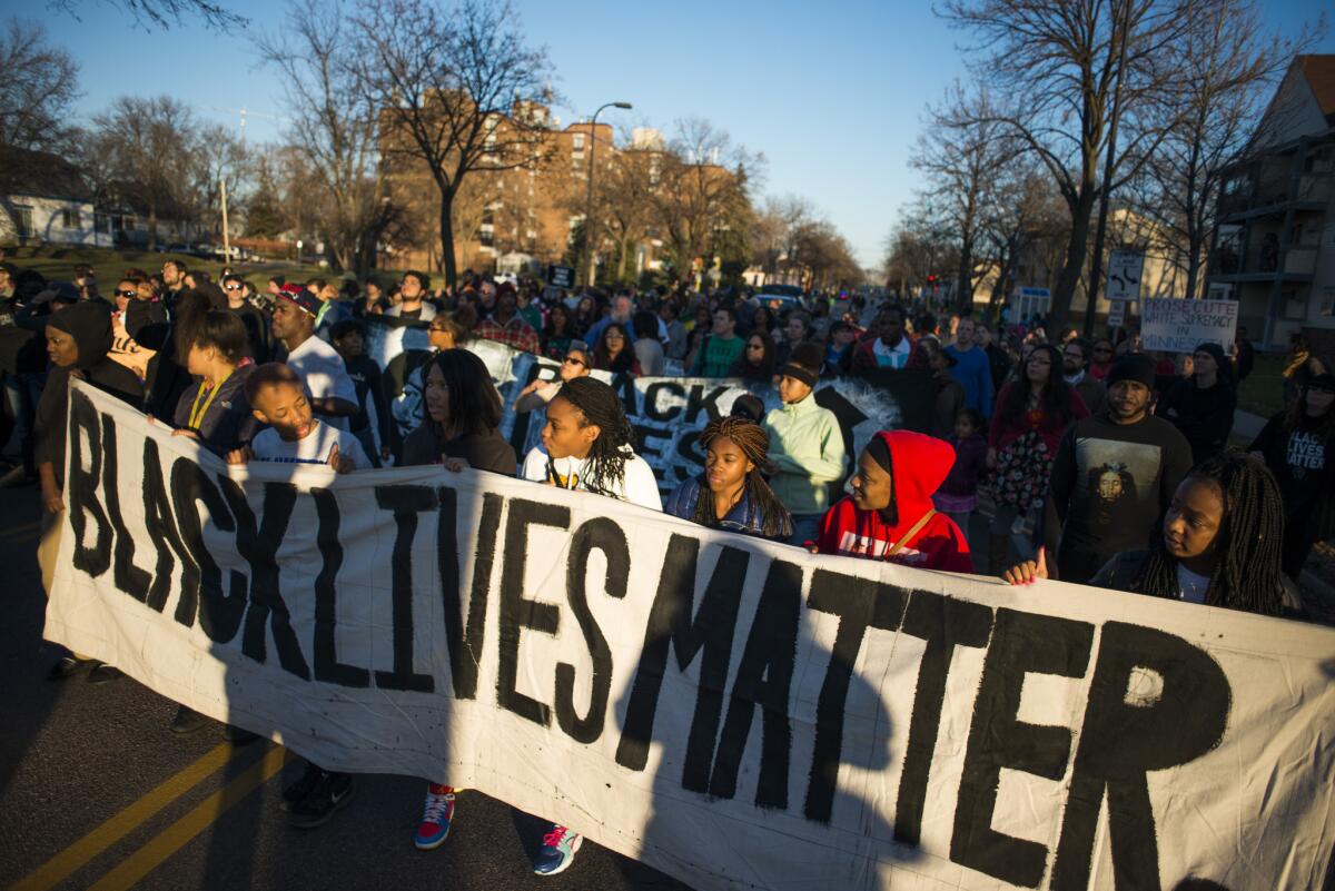 Protesters march down Plymouth Avenue North to the Minneapolis 4th Precinct station. Neighbors and community members gathered at the scene where a man was shot and wounded by a Minneapolis police officer early Sunday.