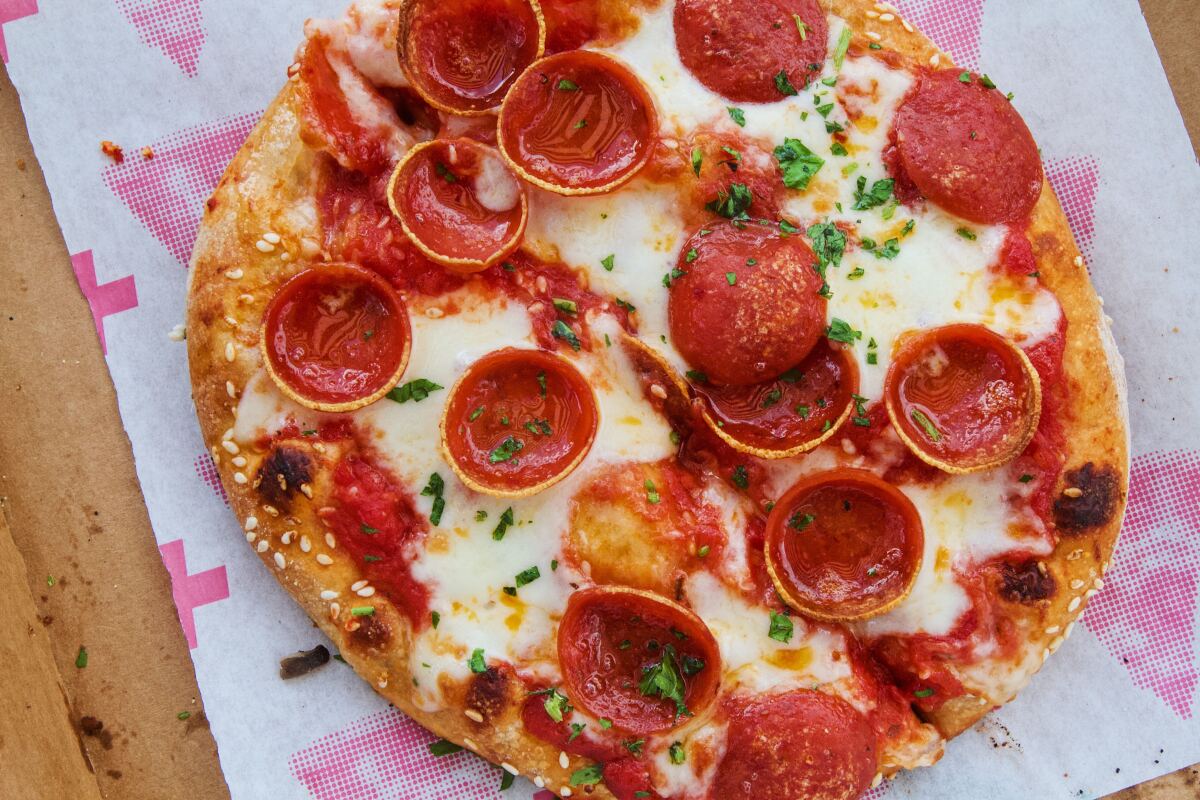 A pizzette topped with cheese, red sauce and pepperoni.