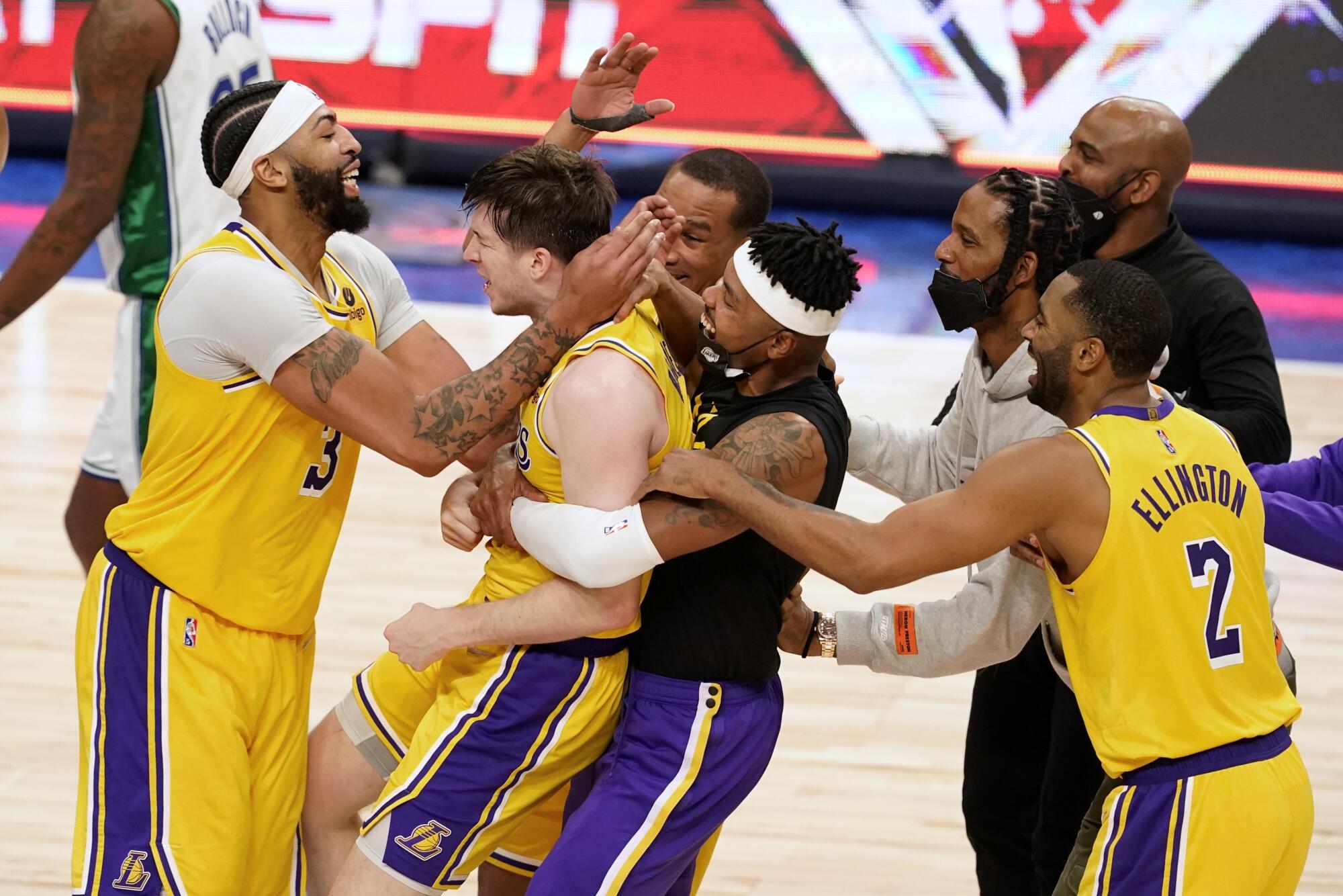 Lakers star Anthony Davis celebrates with Austin Reaves after he made a game-winning three-pointer in overtime against Dallas