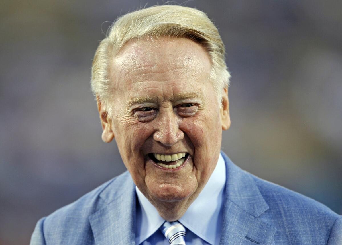 In this photo taken Sept. 23, 2015, Los Angeles Dodgers broadcaster Vin Scully is honored before a baseball game against the Arizona Diamondbacks in Los Angeles.
