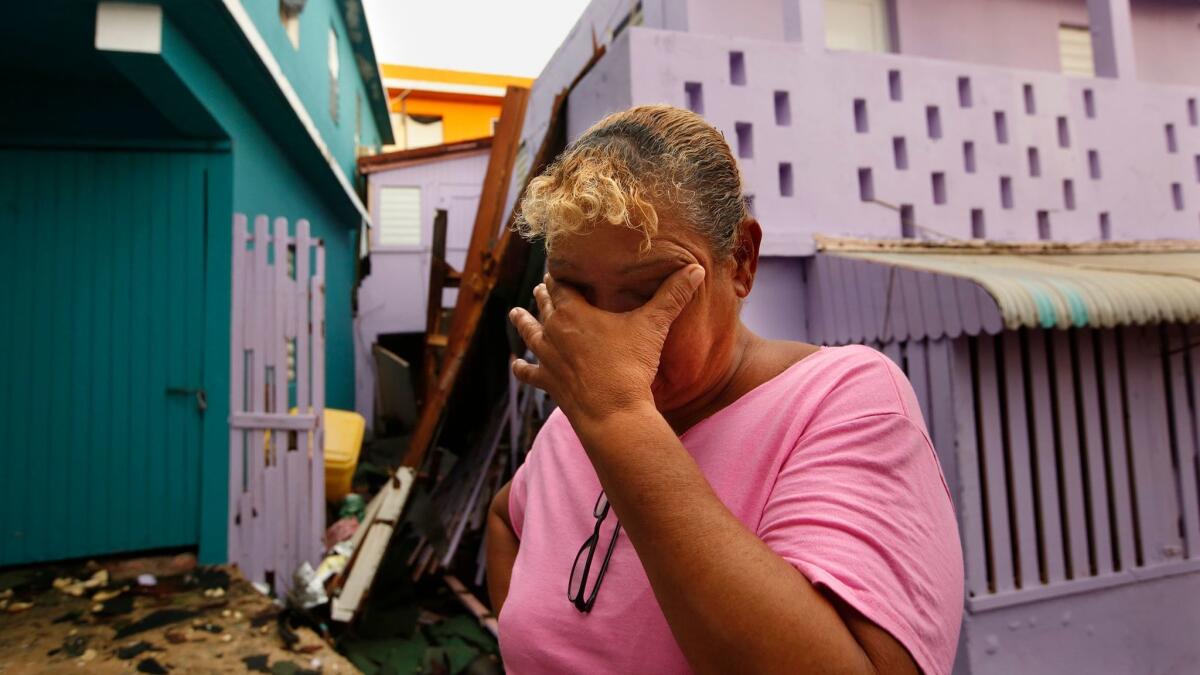 Sonia Viruet, 61, who lives in La Perla, takes stock of the damage to her home and her neighborhood.