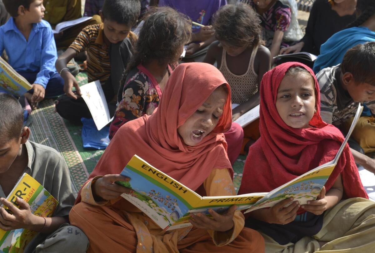 Pakistani children attend a class at a makeshift school on International Literacy Day in Lahore on September 8, 2015.