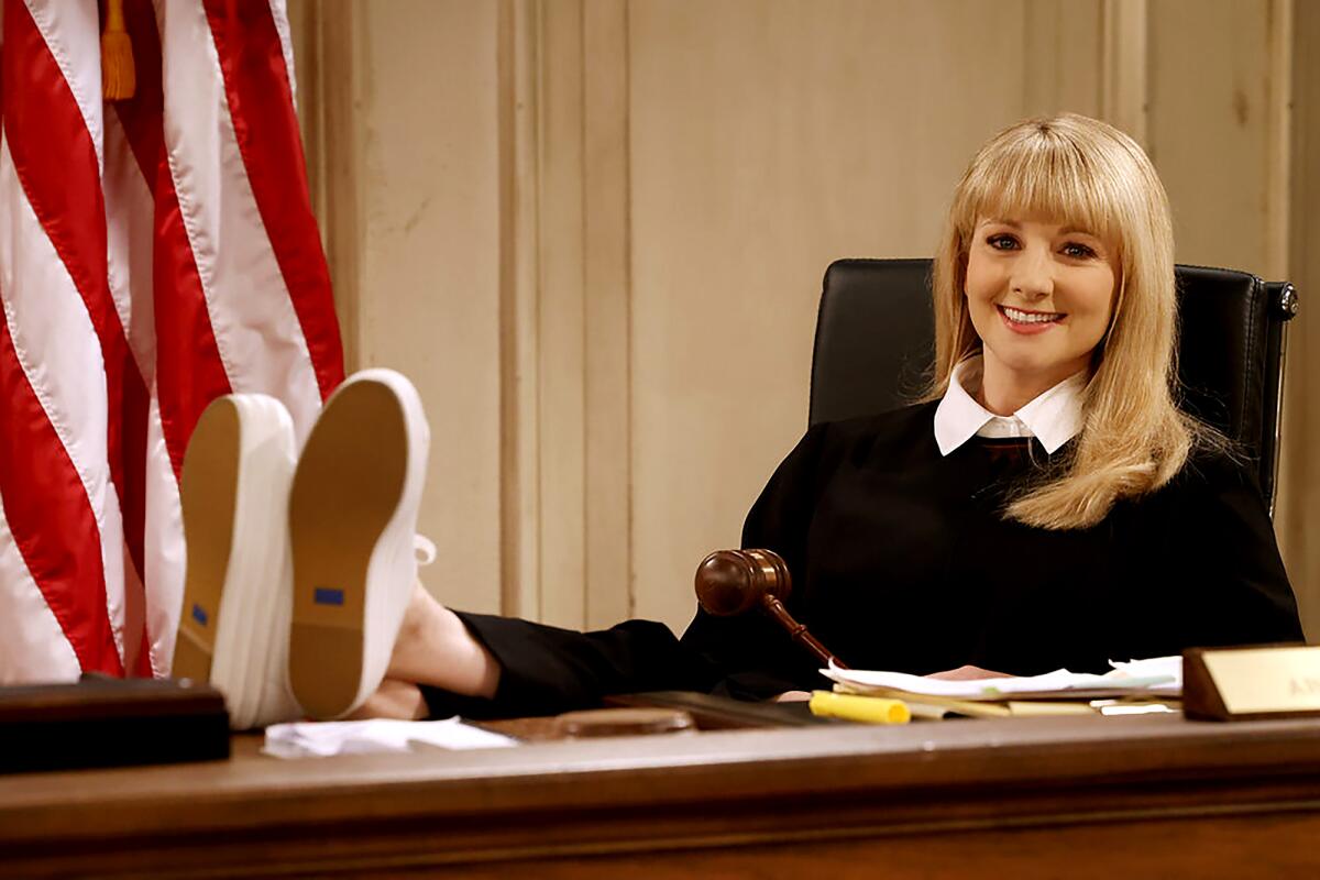 A young judge with her feet on the desk