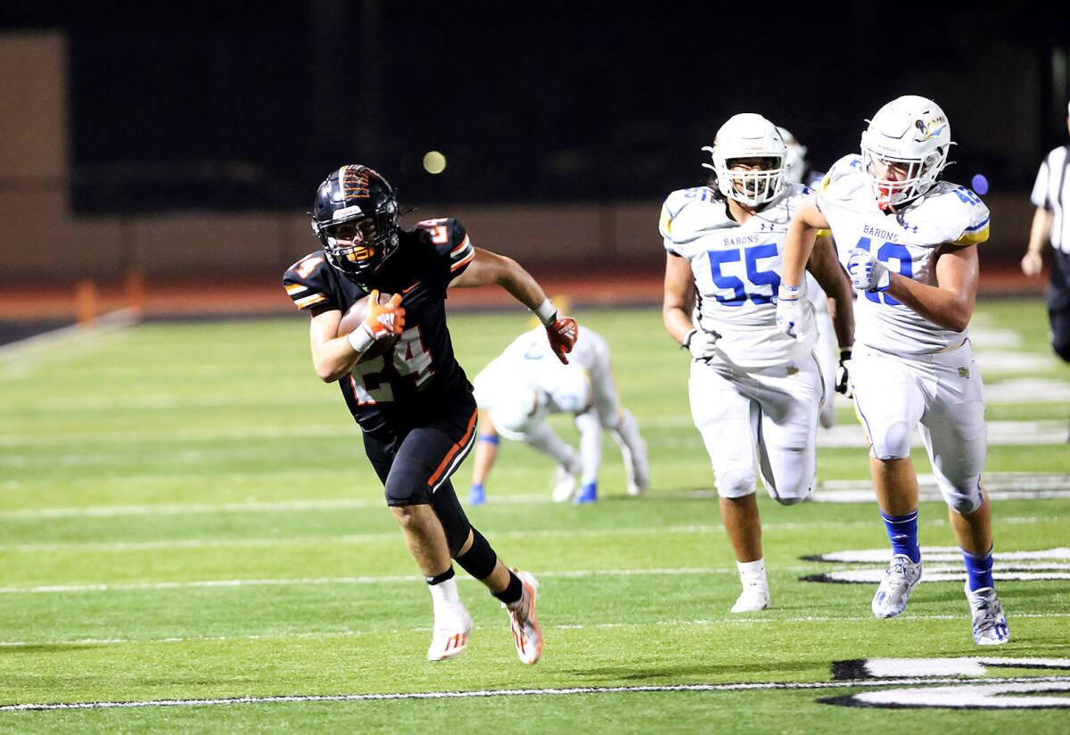Huntington Beach's Evan Riederich (24) runs in for a touchdown in the fourth quarter on Friday.