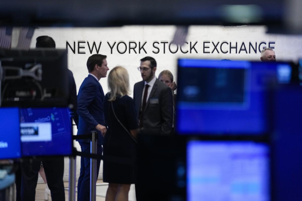 A sign is displayed on the floor of the New York Stock Exchange