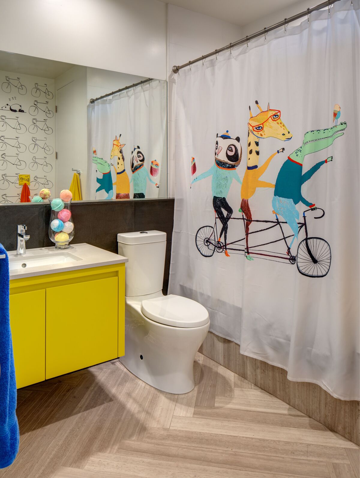 Use fun, colors, patterns and objects for a children’s bathroom — from shower curtains to towels, wallpaper and paint. 