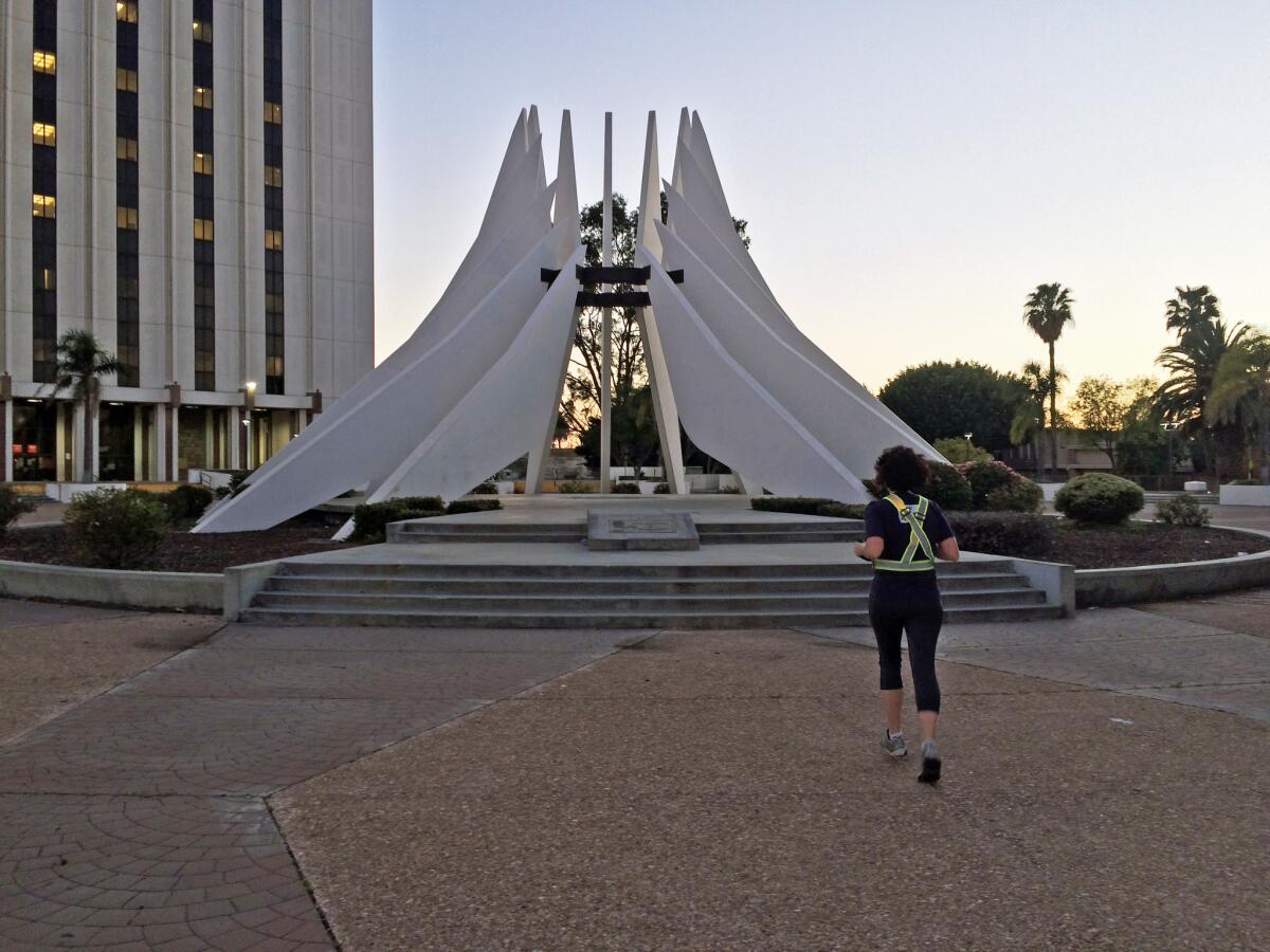 A series of runs adding up to more than 120 miles took a trio of runners all over Los Angeles. Seen here: Abbie Swanson at the Martin Luther King Jr. memorial in Compton.