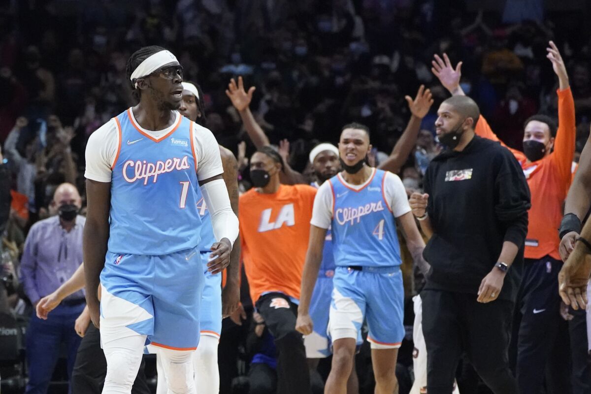 Los Angeles Clippers guard Reggie Jackson (1) celebrates after scoring late in the fourth quarter of an NBA basketball game against the Orlando Magic, Saturday, Dec. 11, 2021, in Los Angeles. (AP Photo/Marcio Jose Sanchez)
