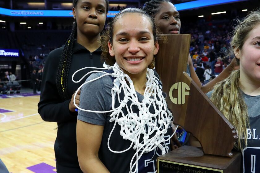 Ashley Chevalier (left) of Sierra Canyon holds state championship trophy. She will try to lead the Trailblazers to back-to-back titles.