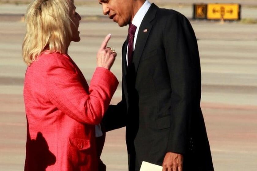 Arizona Gov. Jan Brewer and President Obama in an animated exchange at the airport in Phoenix.