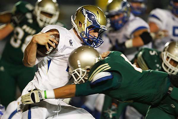 Santa Margarita quarterback Johnny Stanton is stopped by a Long Beach Poly defender after a short gain.