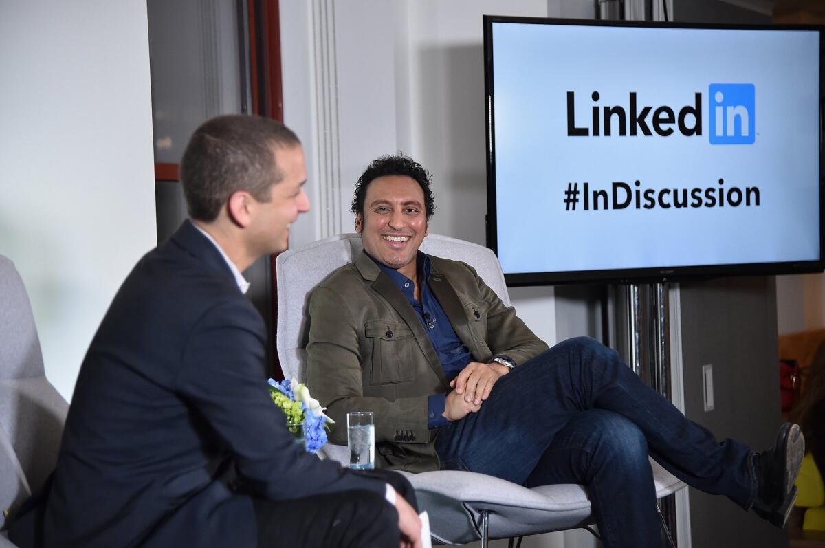Dan Roth, LinkedIn executive editor, talks with actor and comic Aasif Mandvi at a LinkedIn discussion series in New York on March 31.