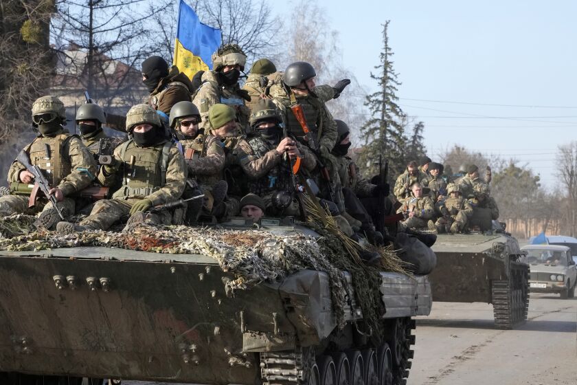FILE - Ukrainian soldiers ride a tank through the town of Trostsyanets, some 400 km eastern of capital Kyiv, Ukraine, Monday, March 28, 2022. Ukraine's Defense Minister Hanna Malyar said recently that the Russian forces were firing 10 times more ammunition than the Ukrainian military. (AP Photo/Efrem Lukatsky, File)