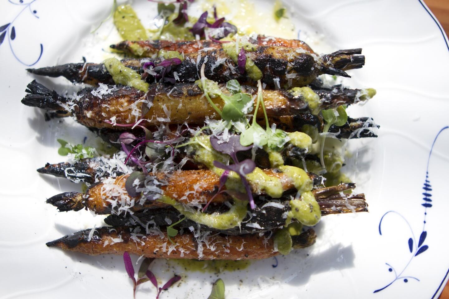 Carrots at the vegetable-focused Commissary are roasted, drizzled with tart yogurt, sprinkled with radish sprouts and served with green sauce. Just point at the picture of a carrot on the menu.