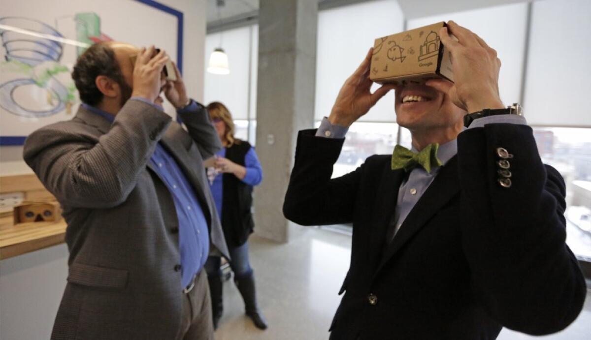 Guests at the Google Chicago headquarters check out Google Cardboard virtual reality headsets.