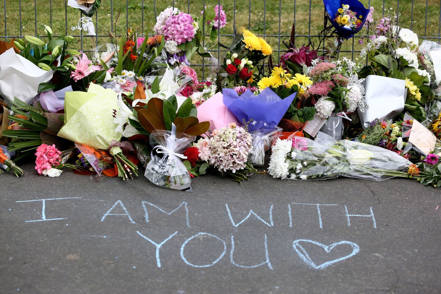 Dunedin residents leave flowers and messages at a local mosque in tribute to Christchurch victims.