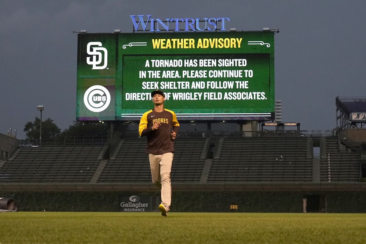 Padres pitcher Yu Darvish runs on the field just before a storm that spawned a tornado warning descended on Wrigley Field.