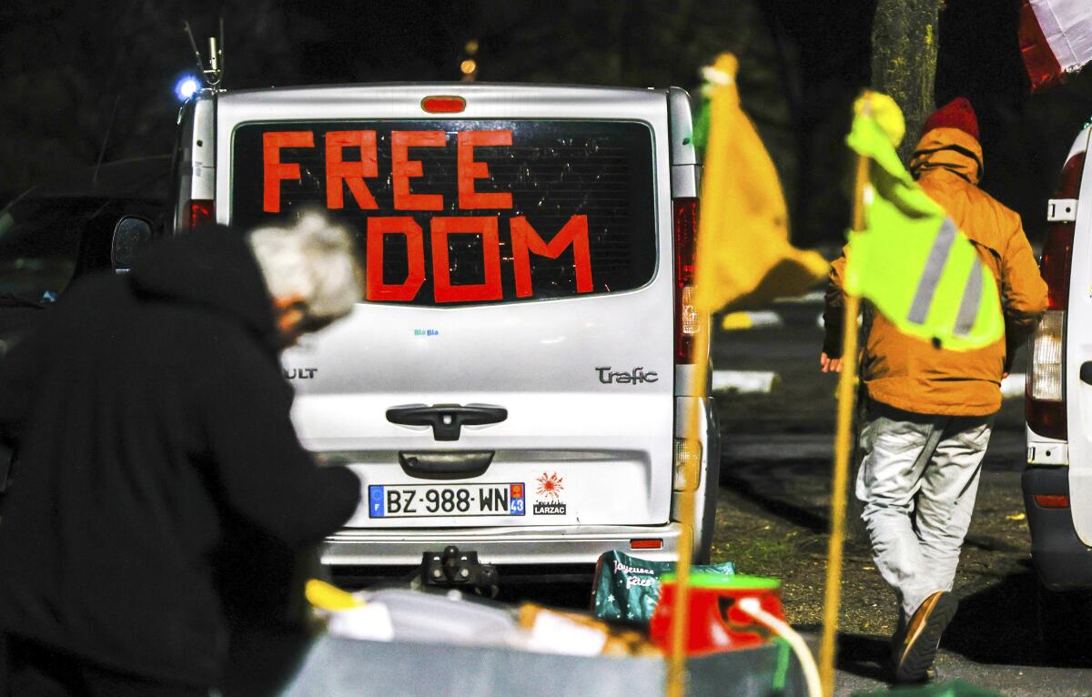 Vehicle with word "Freedom" in tape in its window.